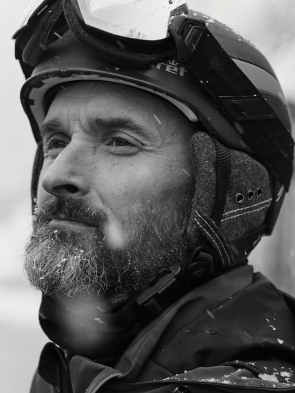 Man in ski helmet and goggles in the snow.