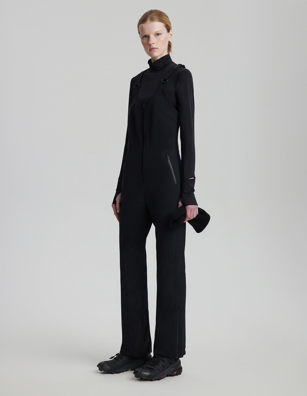 Person wearing a black outfit on a plain background