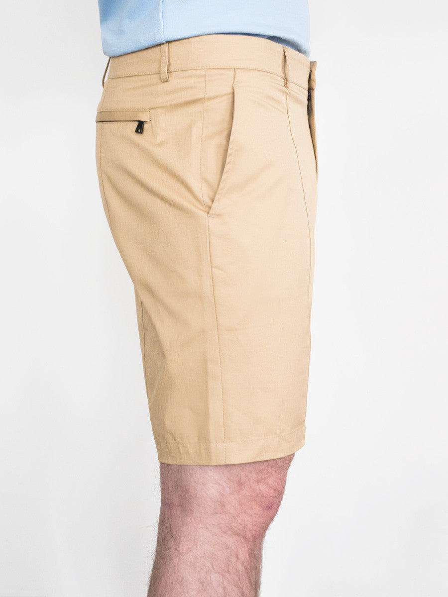 Khaki cotton shorts with side pockets and a back button pocket, mid-thigh length.